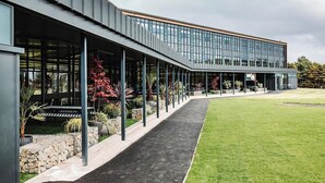A modern building with a covered walkway and a grassy lawn. - Student Only Space St.Andrews (St. Andrews)
