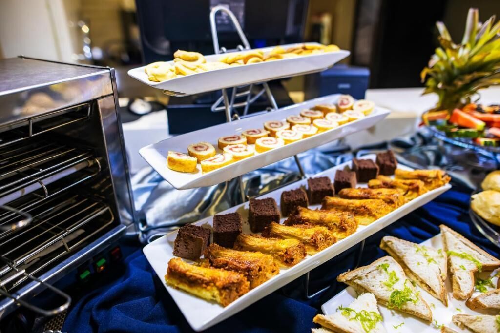 A buffet with various food items including pastries, bread, and desserts.