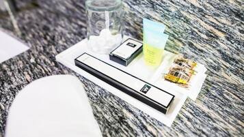 A tray with toiletries on a granite countertop.