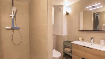 Shower, hair dryer, towels, toilet paper