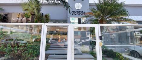 A residential building with a sign for 'ONDINA RESIDENCE' and a 'NAYMEGAS' sign.