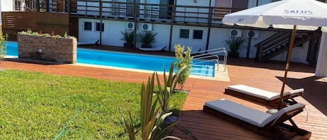 Sesongbasert utendørsbasseng, bassengparasoller og solsenger