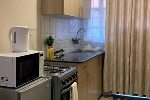 Private kitchen - The Nest Homes – A Cozy & Stylish Studio Retreat Near the City (Nairobi)