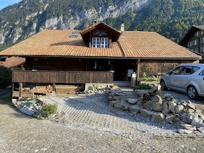 A rustic mountain lodge with a tiled roof, wooden exterior, and a car parked in front. - Lake View Chalet , Därligen (Darligen)