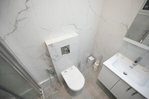 A bathroom with a toilet, sink, and shower. - Central 1 Bdrm Apartment in Pangrati (Athens)