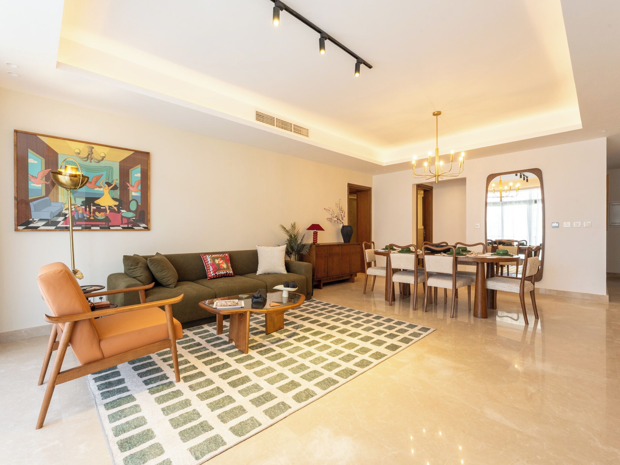 Una sala de estar moderna con un sofá, un sillón, una mesa de centro y un comedor con sillas y una mesa.