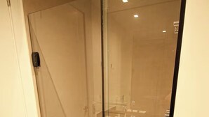 A glass-enclosed shower stall with a toilet visible through the glass. - Vn Consolação 710 (São Paulo)