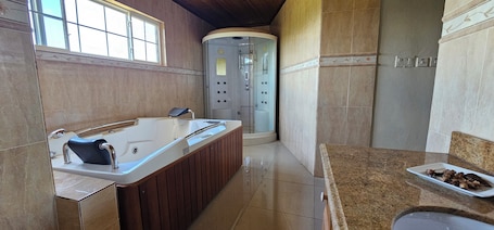 Shower, jetted tub, towels, soap. Living Pretty - Elegant 8 Bedroom Villa in Peaceful Ingleside, Mandeville.