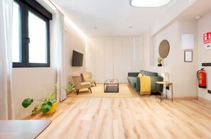 Una sala de estar moderna con un sofá, sillones, una mesita de centro y una chimenea.