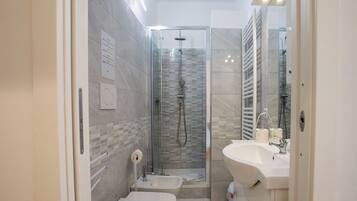 Een douche, een haardroger, een bidet, handdoeken