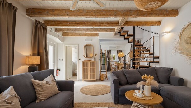 A modern living room with two sofas, a coffee table, and a staircase leading to another level. - Charming Villa Vin with pool near Poreč (Brčići)