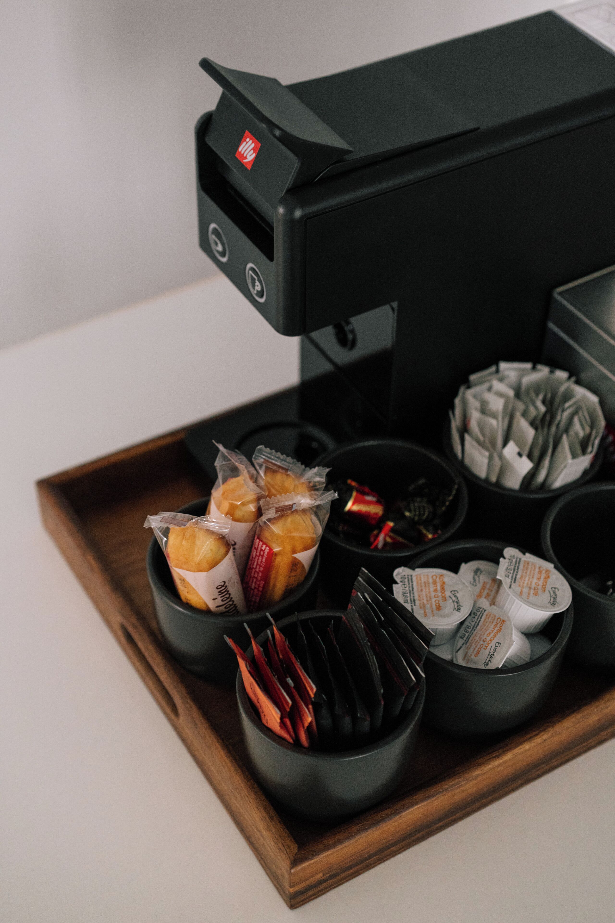 A tray with various food items and a coffee machine.