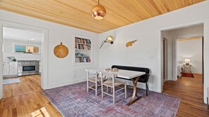 A modern kitchen with a built-in oven and a dining area with a table and chairs. - 2-bedroom house in lovely Santa Fe (Santa Fe)