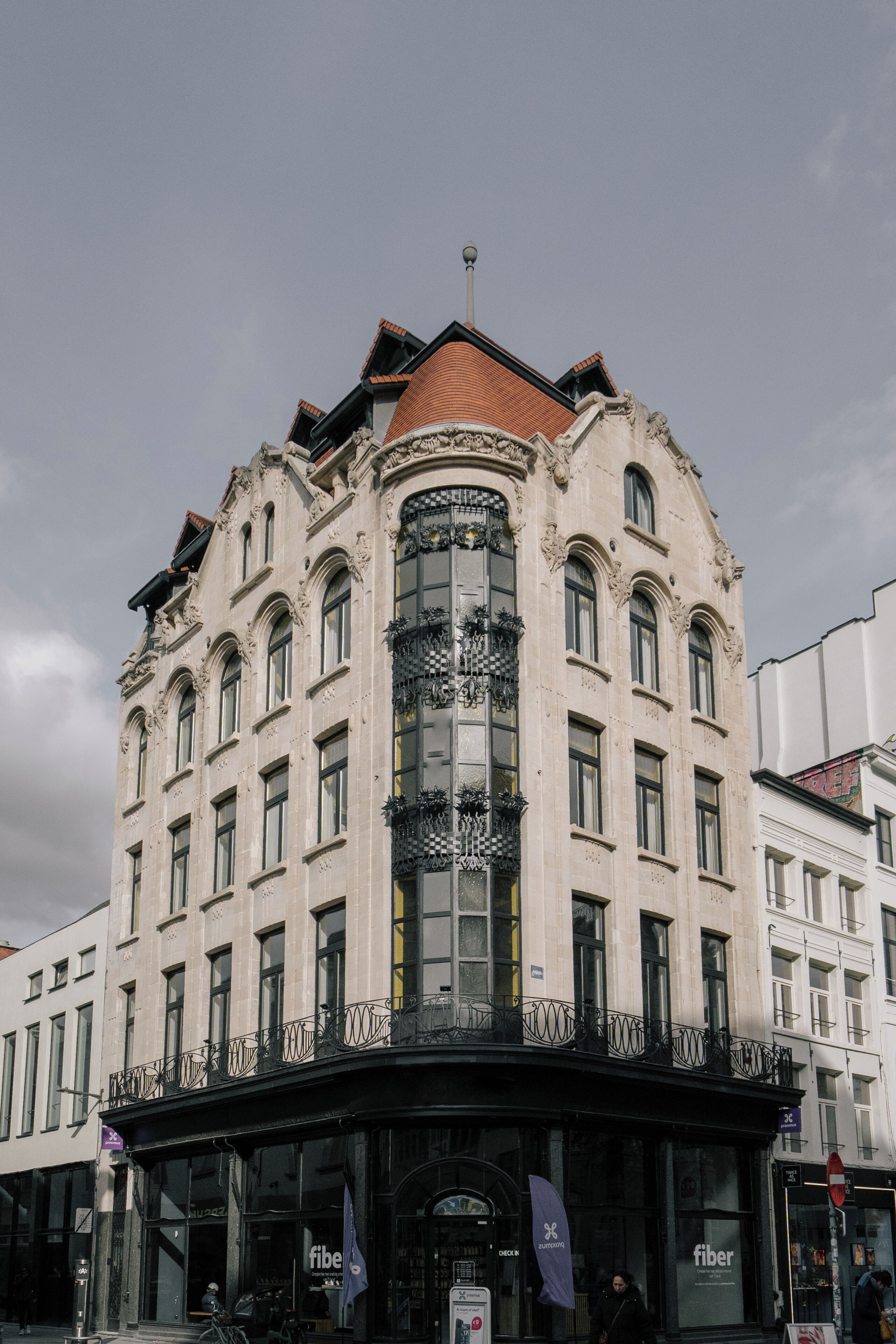 A historic building with ornate architecture, large windows, and a prominent glass facade.