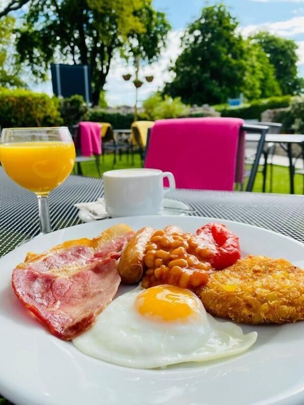A breakfast plate with eggs, bacon, sausages, beans, and toast. - Anchorage Hotel & Spa (Torquay)