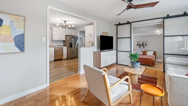 A modern apartment with a kitchen, dining area, and living room. - The Yellow Door Home for 8 (Franklin)