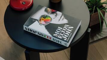 A round table with a book titled "Nihonga: The Art of Japanese Brushwork" and a red desk lamp.