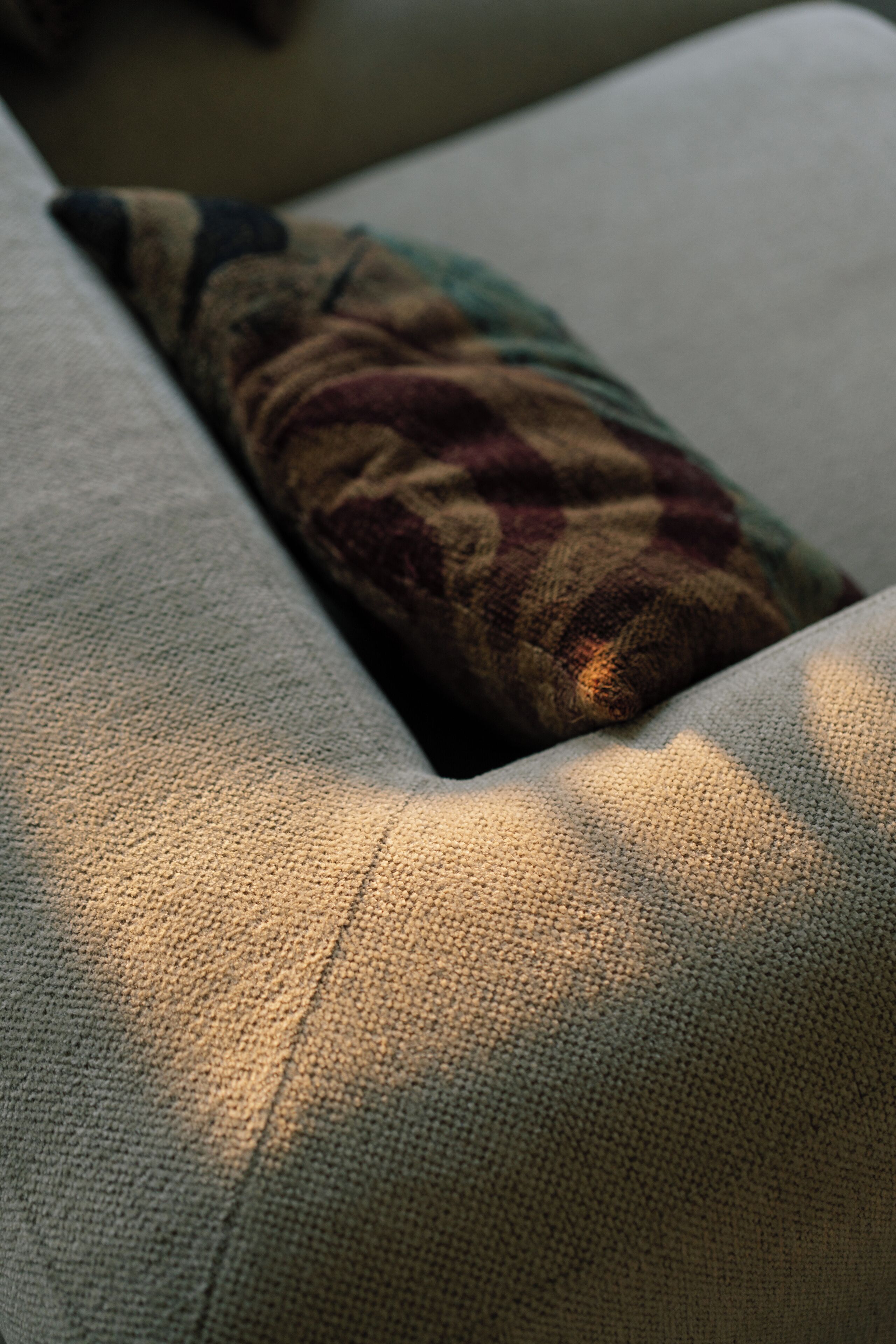 A close-up of a textured fabric surface, likely part of a piece of furniture.