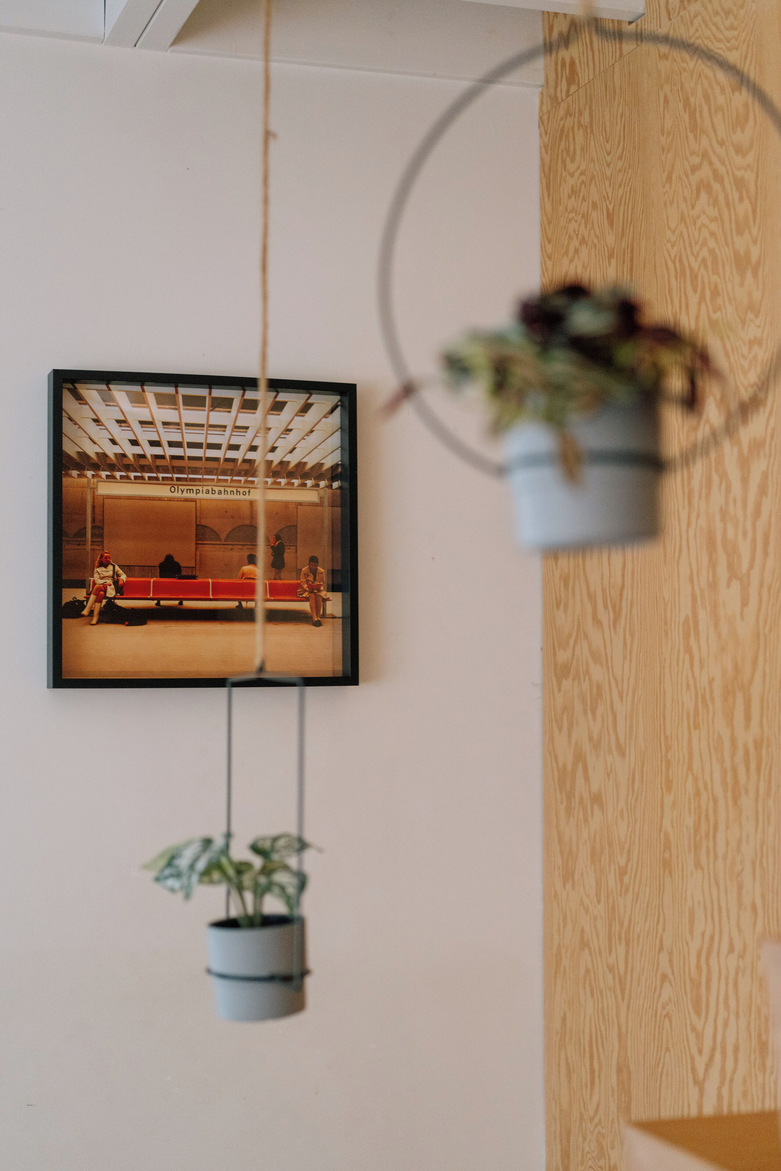 A framed photograph of a train station interior with benches and people.