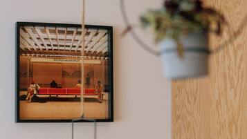 A framed photograph of a train station interior with benches and people.