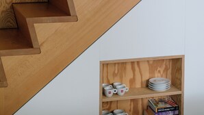 A wooden staircase with a built-in shelf at the bottom. - A Place - Leeuwenstraat 15 (Antwerp)