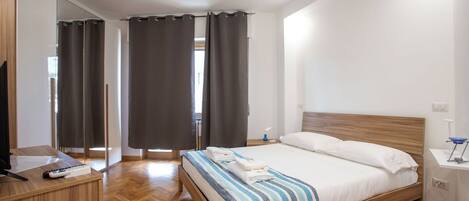 Desk, laptop workspace, blackout curtains, iron/ironing board