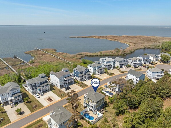 An aerial view of a residential area with houses, a dock, and a body of water. - Sound Legacy: Private Pool and Hot Tub (Corolla)