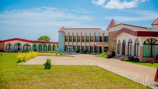 A building with a central courtyard, multiple windows, and a fountain.