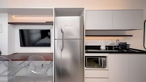 Une cuisine moderne équipée d’un réfrigérateur, d’un four et d’un four à micro-ondes intégrés.