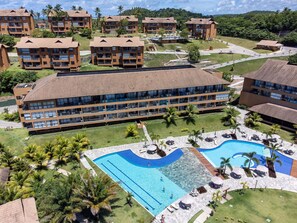 A hotel with multiple buildings, a central swimming pool, and surrounding greenery. - Eco Resort Praia dos Carneiros Luxury Apt (Praia dos Carneiros)