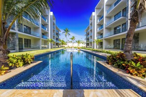 Outdoor pool, sun loungers - Stylish 1BR Apartment – Pool Access, Close to Beach (Punta Cana)