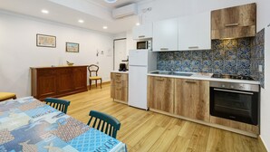 Eine moderne Küche mit Holzausstattung, einem Einbauofen und einer gefliesten Spritzschutzwand.