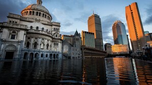 A historic building with a dome and classical architecture, adjacent to modern skyscrapers and a waterfront. - Stylish Studio in South End (Boston)