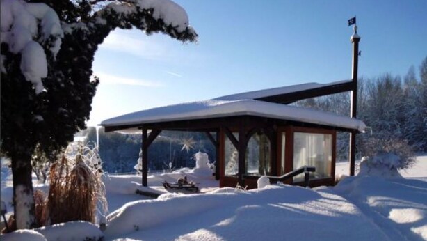 A snow-covered gazebo with a clear view of the surrounding landscape.