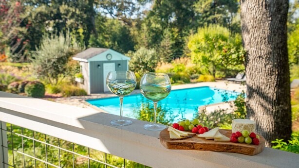 A balcony with a pool, a small shed, and a fruit and cheese board. - 4BR Pool Home | Pet-Friendly | Glen Ellen | Near Jack London Park | Sleeps 8 (Glen Ellen)