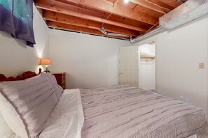 A bedroom with a bed, a nightstand, a lamp, and a wooden ceiling. - Dog-Friendly Mountain View Near Flathead Lake (Somers)