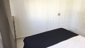A room with a bed, a white door, and a white wall. - 06 Ap2116 in Denia With 2 Bedrooms and 1 Bathrooms (Denia)