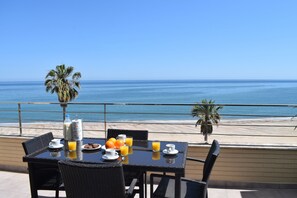 A table with breakfast items and a view of the ocean. - 03 At1102 in Denia With 1 Bedrooms and 2 Bathrooms (Denia)