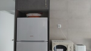 A compact kitchen with a white refrigerator, a microwave, and a toaster. - Ap2133 in Denia With 2 Bedrooms and 1 Bathrooms (Denia)