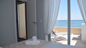 A bedroom with a large window, a bed with white linens, and a view of the sea. - 09 At1101 in Denia With 1 Bedrooms and 2 Bathrooms (Denia)