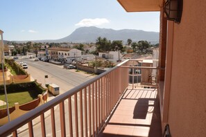A balcony with a view of a street, buildings, and a mountain. - Ap3212 in Denia With 3 Bedrooms and 2 Bathrooms (Denia)