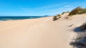 A sandy beach with gentle waves and a clear sky. - Dup3291 in Oliva With 3 Bedrooms and 2 Bathrooms (Oliva)
