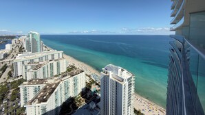 A high-rise hotel overlooking a beach with clear turquoise waters and a distant horizon. - 37th Floor OCEAN VIEW Retreat - 2BR Hollywood (Hollywood)