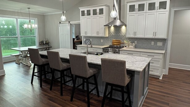 A modern kitchen with a large island, white cabinetry, and a herringbone backsplash. - AUGUSTA MASTERS RENTAL_Spacious 5-bedroom house in fantastic Appling (Appling)