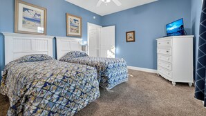 A bedroom with two beds, a ceiling fan, a dresser, and a television. - Magnolia Pointe Magnolia Lake 4812-302 (Myrtle Beach)