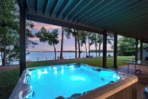 A hot tub under a covered area with a view of a lake and trees. - Lake Norman Getaway (Mooresville)