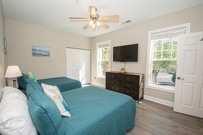 A bedroom with two beds, a ceiling fan, a TV, and a dresser. - World Tour 100-201a (Myrtle Beach)