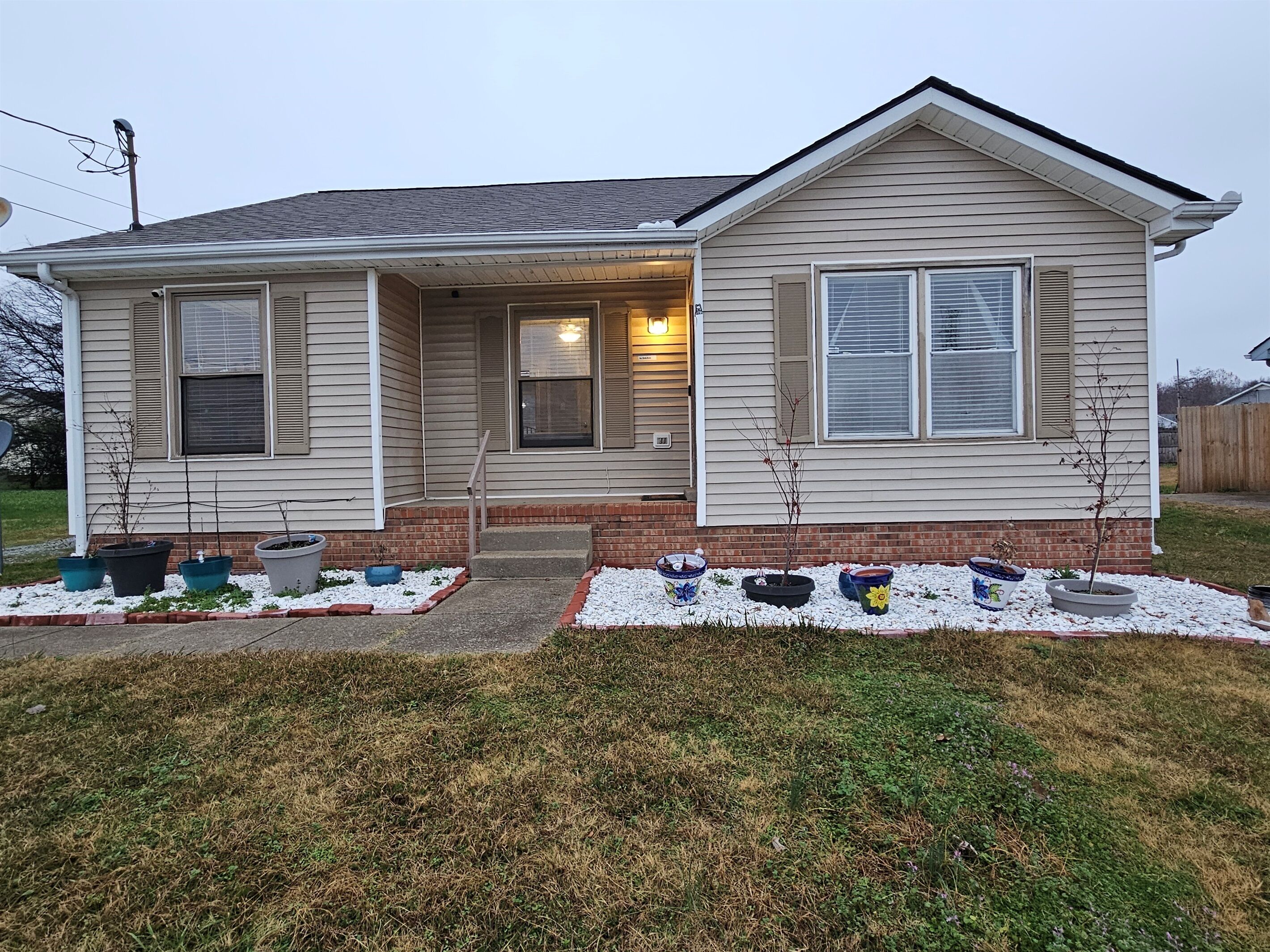 A single-story house with a front porch, a small entryway, and a garage.