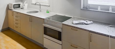 Fridge, microwave, coffee/tea maker, cookware/dishes/utensils
