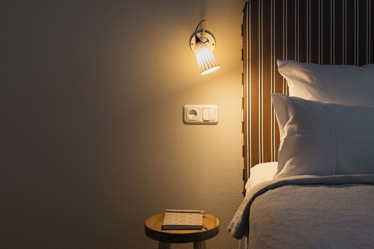 Premium bedding, laptop workspace, blackout drapes, soundproofing